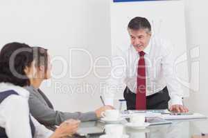 Businessman leaning on desk