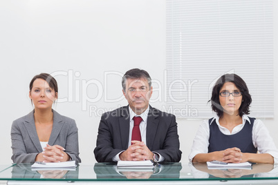 Three business people folding their hands