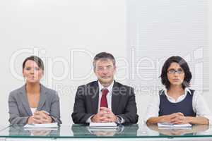 Three business people folding their hands