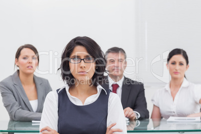 Four business people with serious expressions