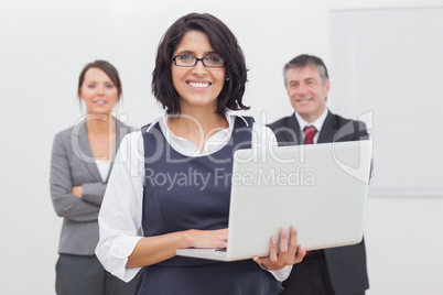 Businesswoman standing with laptop