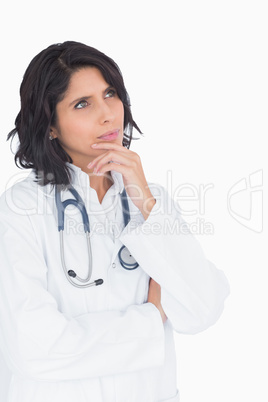 Cute doctor thinking with hand to the chin