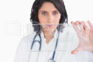 Doctor holding up virtual screen in hands