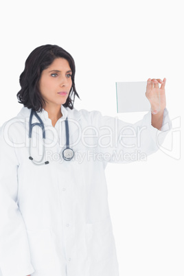 Female doctor looking at virtual clear screen