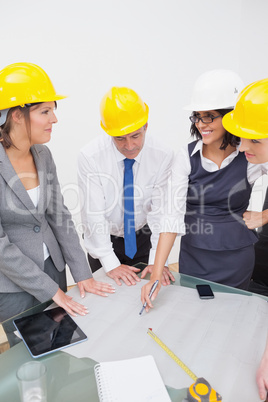 Team looking at a construction plan and laughing