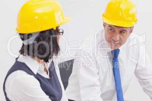 Two architects speaking with yellow helmet