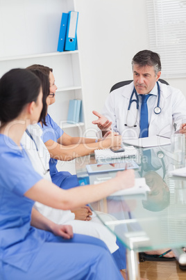 Meeting between a doctor and three nurses