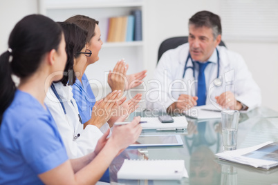 Nurses cheering a doctor