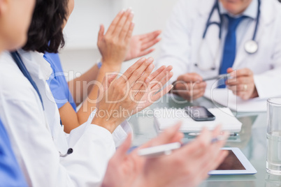 Nurses clapping a doctor