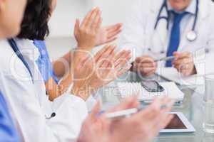 Nurses clapping a doctor