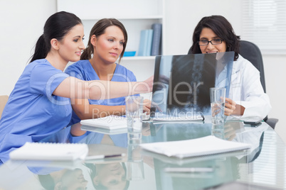 Nurse and doctor looking at x-ray