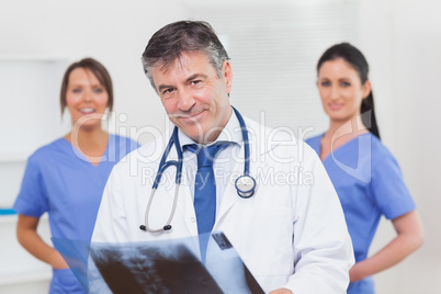 Doctor with x-ray and his team