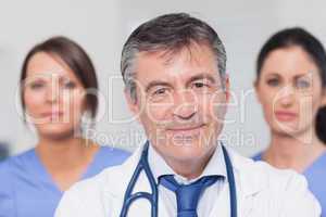 Smiling doctor with two nurses