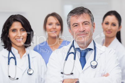 Two doctors and two nurses smiling