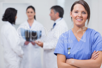 Nurse smiling with her team taking x-ray seriously