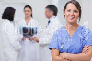 Nurse smiling with her team taking x-ray seriously