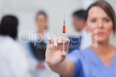 Nurse showing syringe