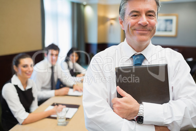 Businessman holding folder at conference