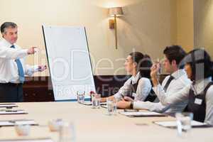 Businessman answering question during presentation