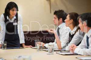 Woman asking question in business meeting
