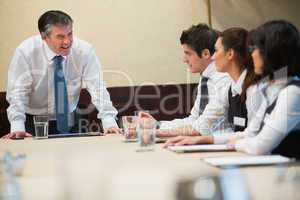 Angry boss in business meeting