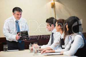 Businessman using tablet in meeting