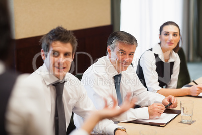 Happy business people listening to presentation