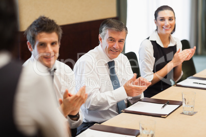 Business people clapping after a presentation