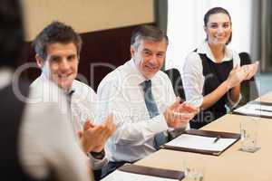 Business people clapping after a presentation