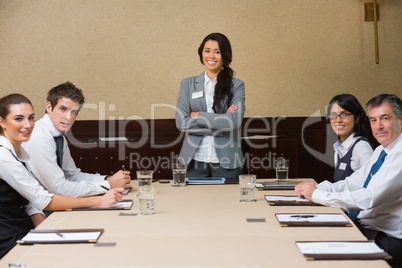 Smiling woman at head of business meeting