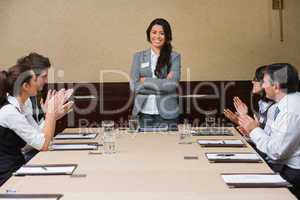 Businesswoman being applauded by peers