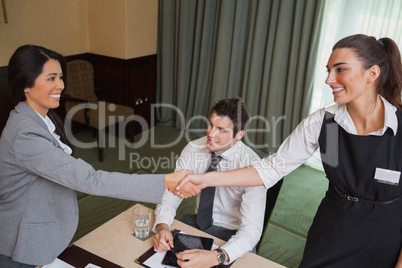Women shaking hands during business meeting