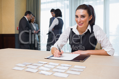 Smiling woman at welcome desk