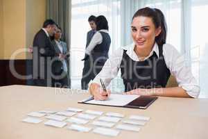 Smiling woman at welcome desk