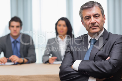 Serious businessman with arms crossed