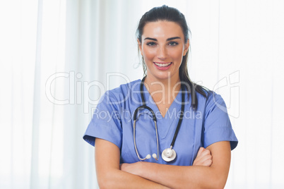 Happy nurse with arms crossed