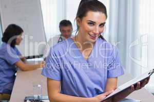 Nurse standing with clipboard