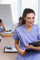 Smiling nurse with clipboard