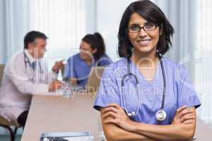 Smiling nurse with arms crossed