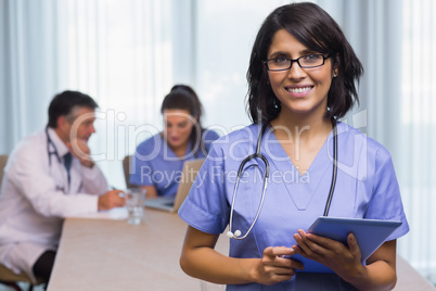 Smiling nurse with tablet pc