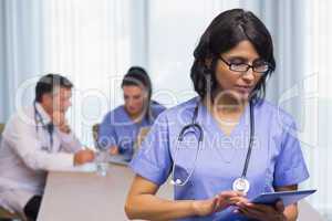 Nurse using digital tablet