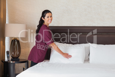 Happy hotel maid at work