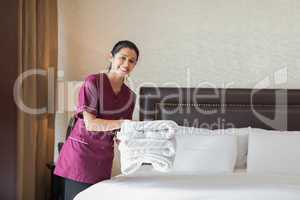 Happy maid working in hotel room