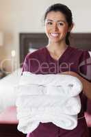 Smiling maid with towels