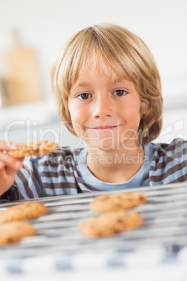 Smiling boy holding a cookie