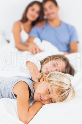 Sleeping children lying on the bed