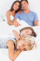Sleeping children lying on the bed