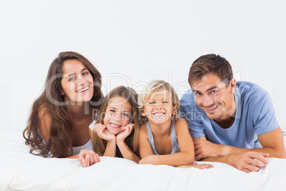 Happy family lying on a bed