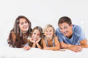 Happy family lying on a bed
