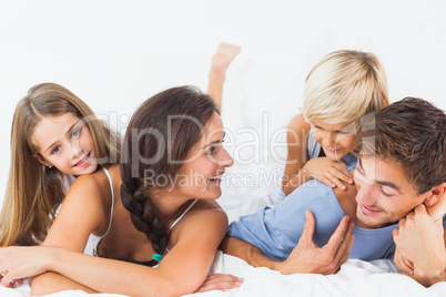 Cheerful parents giving their children piggyback ride